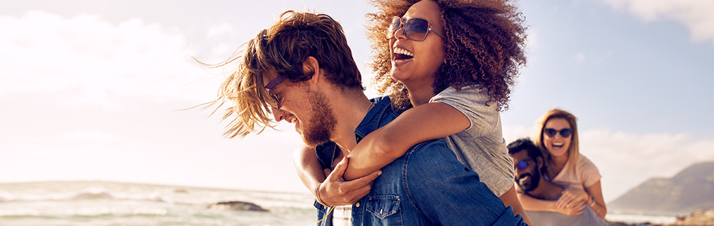 happy couples enjoying the sunshine at the beach