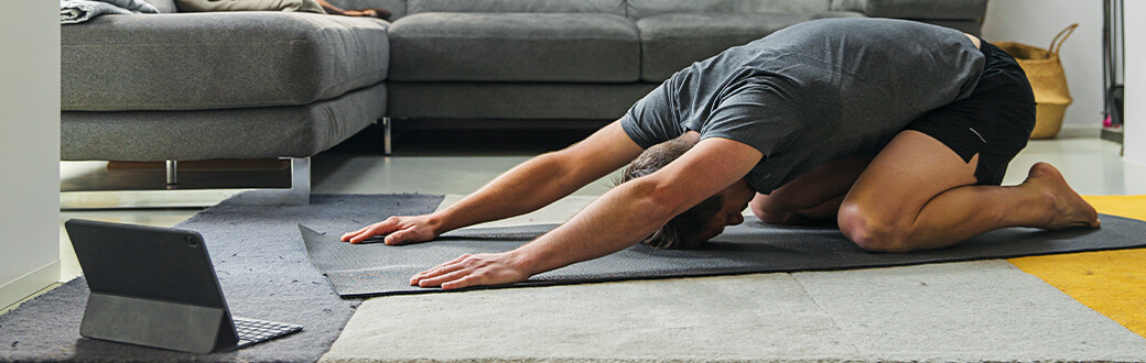 A man stretching indoors.