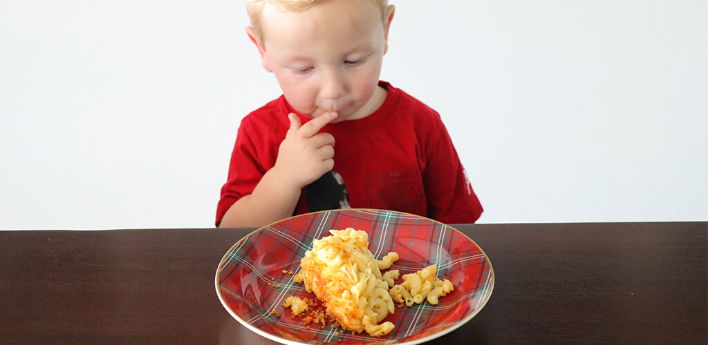 a child eating mac and cheese